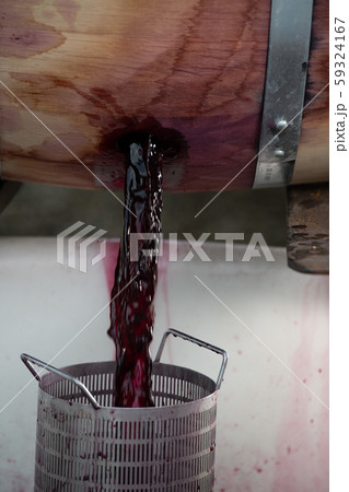 Wine mixing during fermentation process in barrel, Bordeaux Vineyard 59324167
