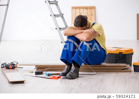 Young male contractor working indoors Young male contractor working indoors 59324171