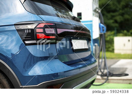 Electric car on gas station. Blue car and electric 59324338