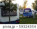 Caravans and campers on green meadow in campsite. 59324354