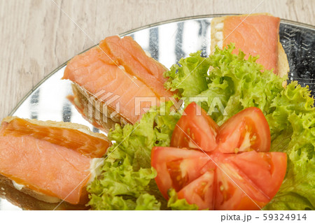 Dish of sandwiches with red fish tomato and greens Dish of sandwiches with red fish tomato and greens 59324914