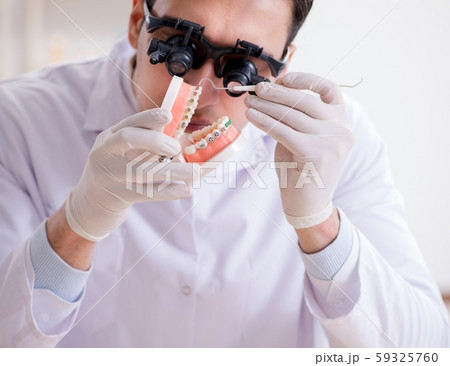 Young dentist working in the dentistry hospital Young dentist working in the dentistry hospital 59325760