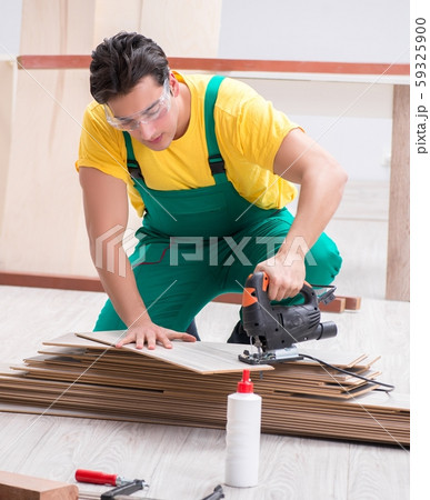 The contractor working on laminate wooden floor The contractor working on laminate wooden floor 59325900
