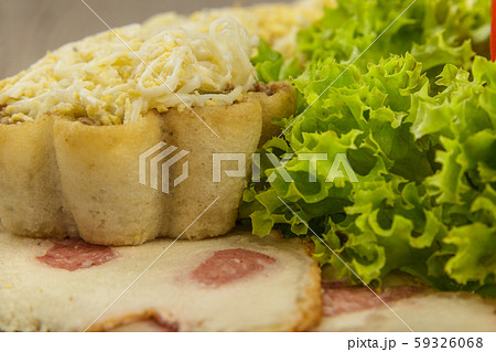 Tartlets with salad on a plate with greens. Tartlets with salad on a plate with greens. 59326068