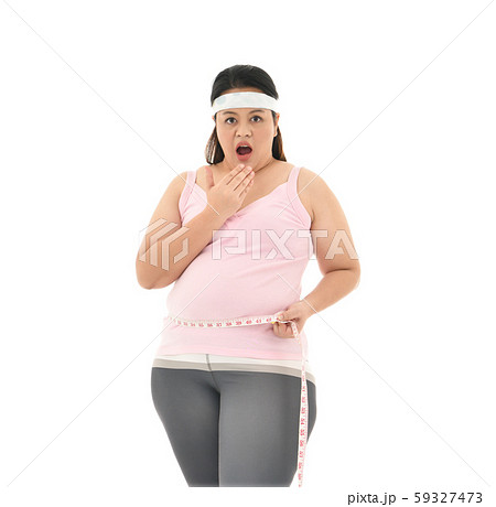 Overweight Asian woman measuring her waistline fat tummy isolated on white background 59327473