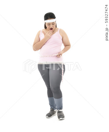 Overweight Asian woman measuring her waistline fat tummy isolated on white background 59327474