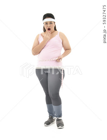 Overweight Asian woman measuring her waistline fat tummy isolated on white background 59327475