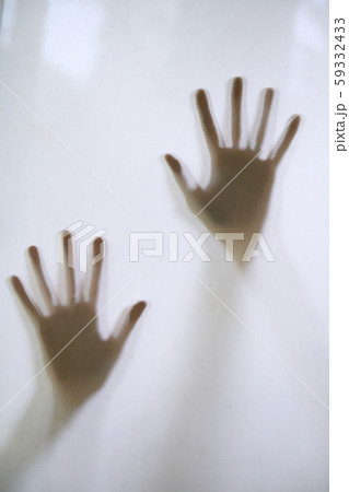 Woman's hands touching frosted glass 59332433