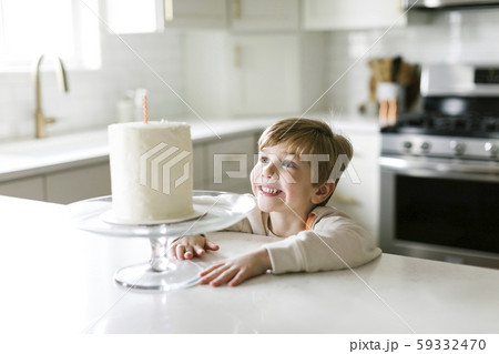 Boy smiling at birthday cake 59332470