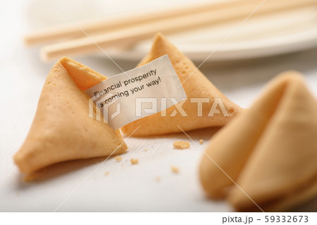 Fortune cookies by chopsticks on plate 59332673