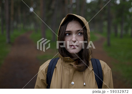 Portrait of young woman wearing brown raincoat Portrait of young woman wearing brown raincoat 59332972