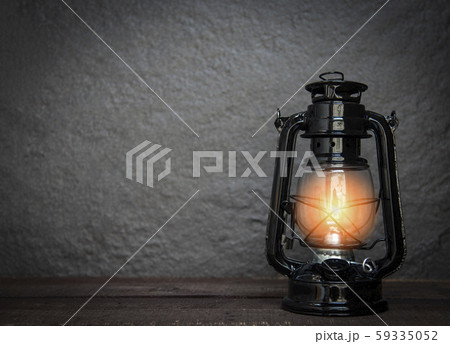 Oil lamp at night on a dark background - old Oil lamp at night on a dark background - old 59335052