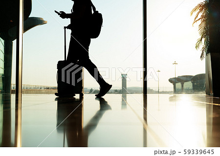 walking traveler with suitcase, passenger for tour in the airport terminal for air traveling walking traveler with suitcase, passenger for tour in the airport terminal for air traveling 59339645