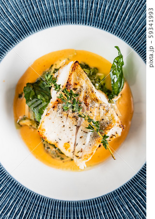 Fried fish fillet. Cod with sauce and herbs 59341993