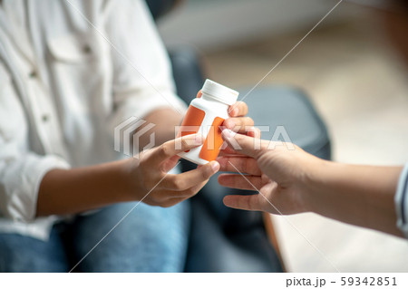Close up of psychoanalyst giving antidepressant to patient 59342851