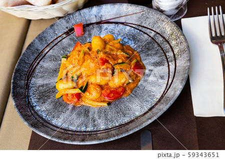 Dumplings from salmon and stew of courgette and tomatoes Dumplings from salmon and stew of courgette and tomatoes 59343651