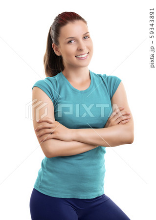 Beautiful fit girl standing with folded arms looking at camera Beautiful fit girl standing with folded arms looking at camera 59343891