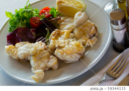 Baked pieces of monkfish 59344115