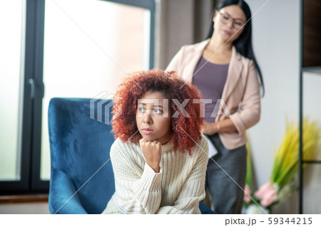 Woman feeling thoughtful while listening to psychoanalyst Woman feeling thoughtful while listening to psychoanalyst 59344215