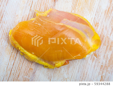 Raw skinless chicken thighs on cutting board 59344288