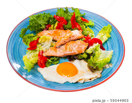 Tasty breakfast with trout, egg, pepper and lettuce at plate on table 59344903