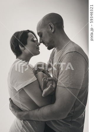 family photo on a white background: parents spend time with their children. mom and dad hug the baby. the concept of childhood, fatherhood, motherhood, IVF family photo on a white background: parents spend time with their children. mom and dad hug the baby. the concept of childhood, fatherhood, motherhood, IVF 59346321