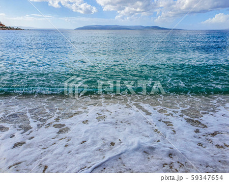 Pebble beach and wave foam 59347654