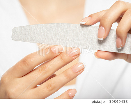 Woman gets manicure procedure in a spa salon. Woman gets manicure procedure in a spa salon. 59349458
