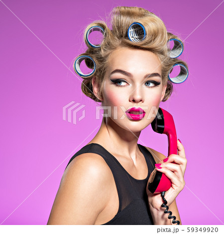 Girl wears curlers in hair with a  looking sad. 59349920