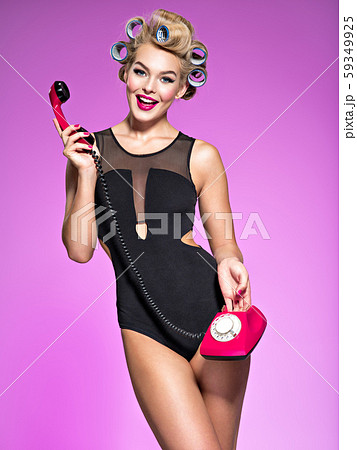 Portrain of an attractive woman using a vintage Portrain of an attractive woman using a vintage 59349925