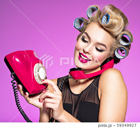 Young girl dials a phone number on an old phone 59349927