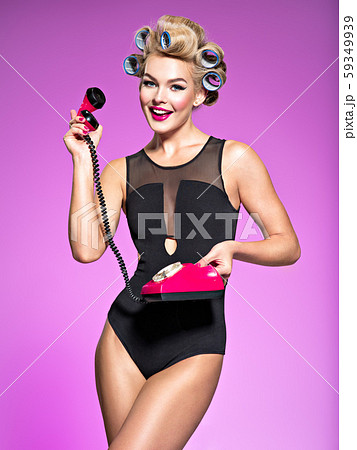 Portrain of an attractive woman using a vintage 59349939