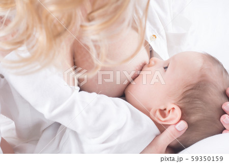 Mother breastfeeding her little baby in her arms 59350159