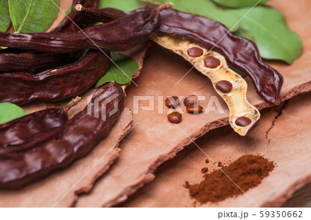 Carob. Organic carob pods with seeds and leaves Carob. Organic carob pods with seeds and leaves 59350662