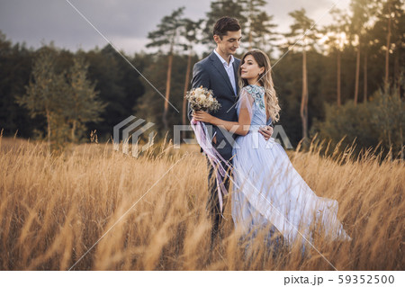 newlyweds are walking on the autumn meadow 59352500