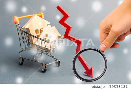 Miniature wooden houses in the supermarket trolley and down arrow. The concept of low housing demand. Discounts for real estate in the winter. Mortgage interest rates. Cheap cost. Christmas Snowflakes Miniature wooden houses in the supermarket trolley and down arrow. The concept of low housing demand. Discounts for real estate in the winter. Mortgage interest rates. Cheap cost. Christmas Snowflakes 59353181