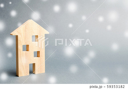 Miniature wooden house and snowflakes. Demand for real estate in the winter. Christmas discounts and sale. Rental of housing. Buying houses and apartments. Favorable prices 59353182
