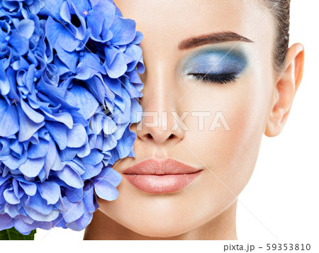 Closeup face of young beautiful woman with a blue 59353810