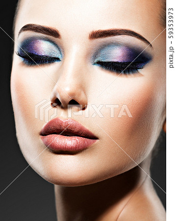 Beautiful face of an young woman with blue makeup Beautiful face of an young woman with blue makeup 59353973