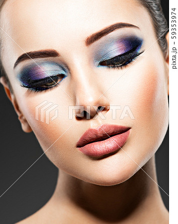 Beautiful face of an young woman with blue makeup Beautiful face of an young woman with blue makeup 59353974