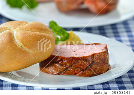 Portion of oven fresh Bavarian meat loaf with a crispy roll and mustard 59358142