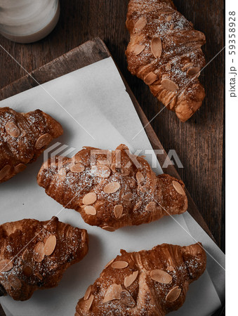 Almond croissant with custard filling on wood 59358928