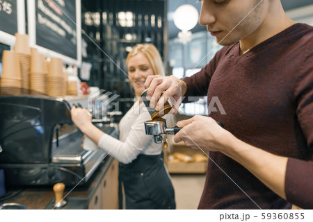 Barista man and woman making coffee, couple of young people working in coffee shop 59360855