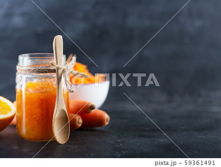 Carrot Jam with orange juice on a black background 59361491