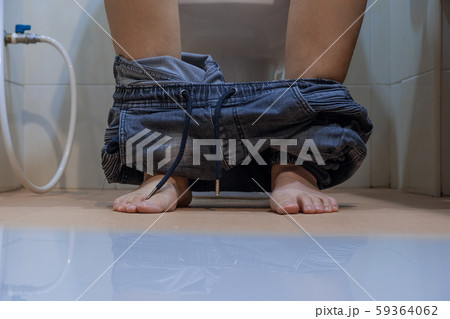 close up woman with constipation sitting on toilet. close up woman with constipation sitting on toilet. 59364062