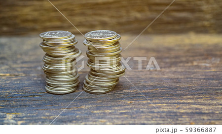 The concept with many silver coins stacked on the old wooden floor. 59366887
