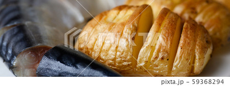 Baked golden potatoes with herring mackerel Baked golden potatoes with herring mackerel 59368294