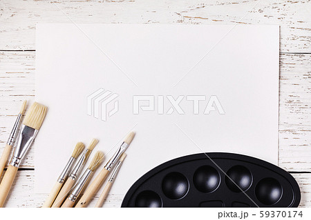 Paint brushes and paints on a wooden table with copy space. Top view on artists tools 59370174