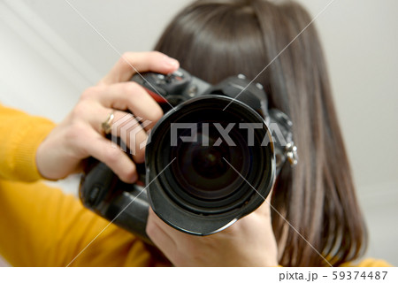 Attractive brunette woman with photo camera in Attractive brunette woman with photo camera in 59374487