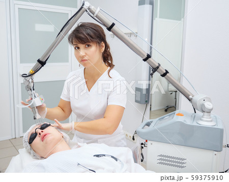 medical salon employee uses neodymium laser removing scars medical salon employee uses neodymium laser removing scars 59375910